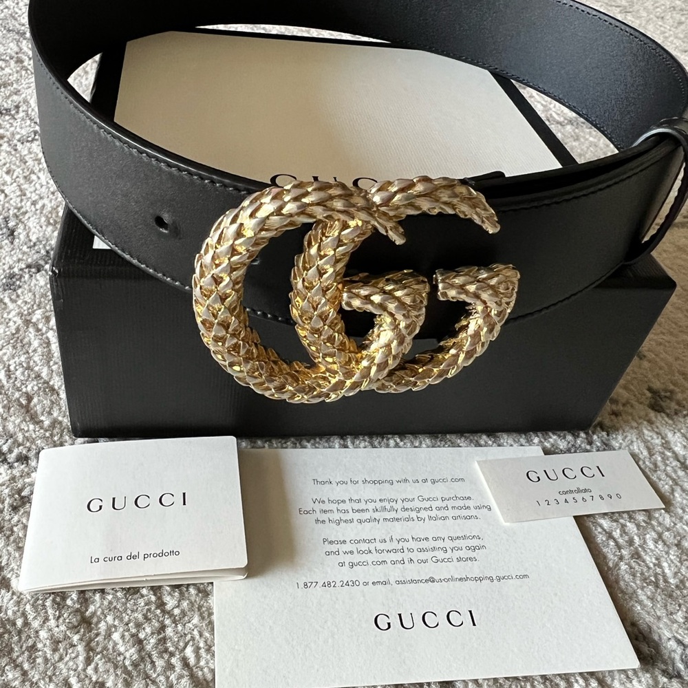 Gold buckle black Gucci belt